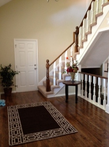 Updated entry. A fresh coat of paint on the spindles, new carpet and area rug welcome prospective buyers to this home.